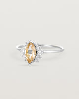 A white gold ring featuring a marquise champagne quartz with a halo of white diamonds