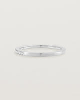 white gold band with half a band of micro pave diamonds