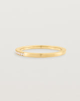 yellow gold band with half a band of micro pave diamonds