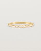 yellow gold band with half a band of micro pave diamonds