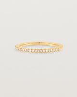 yellow gold band with half a band of micro pave diamonds