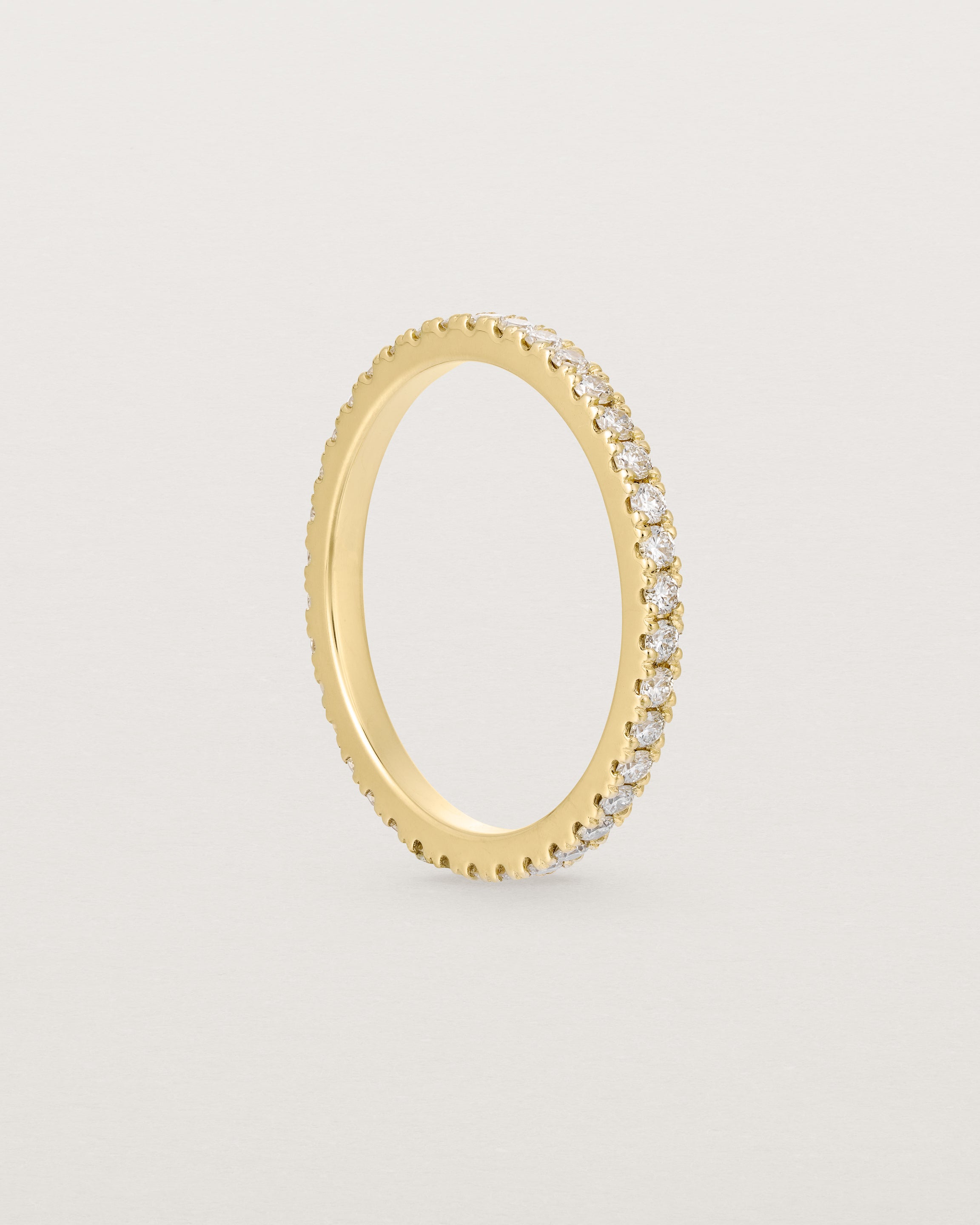 a yellow gold band with white diamonds