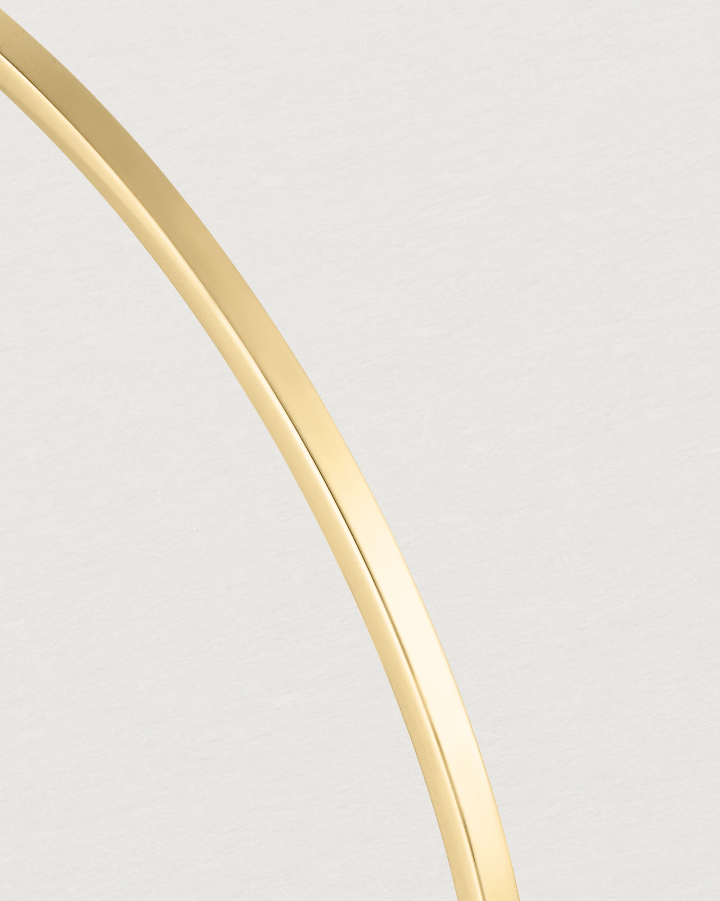 Close up of the detail of the Antares Bangle in Yellow Gold.