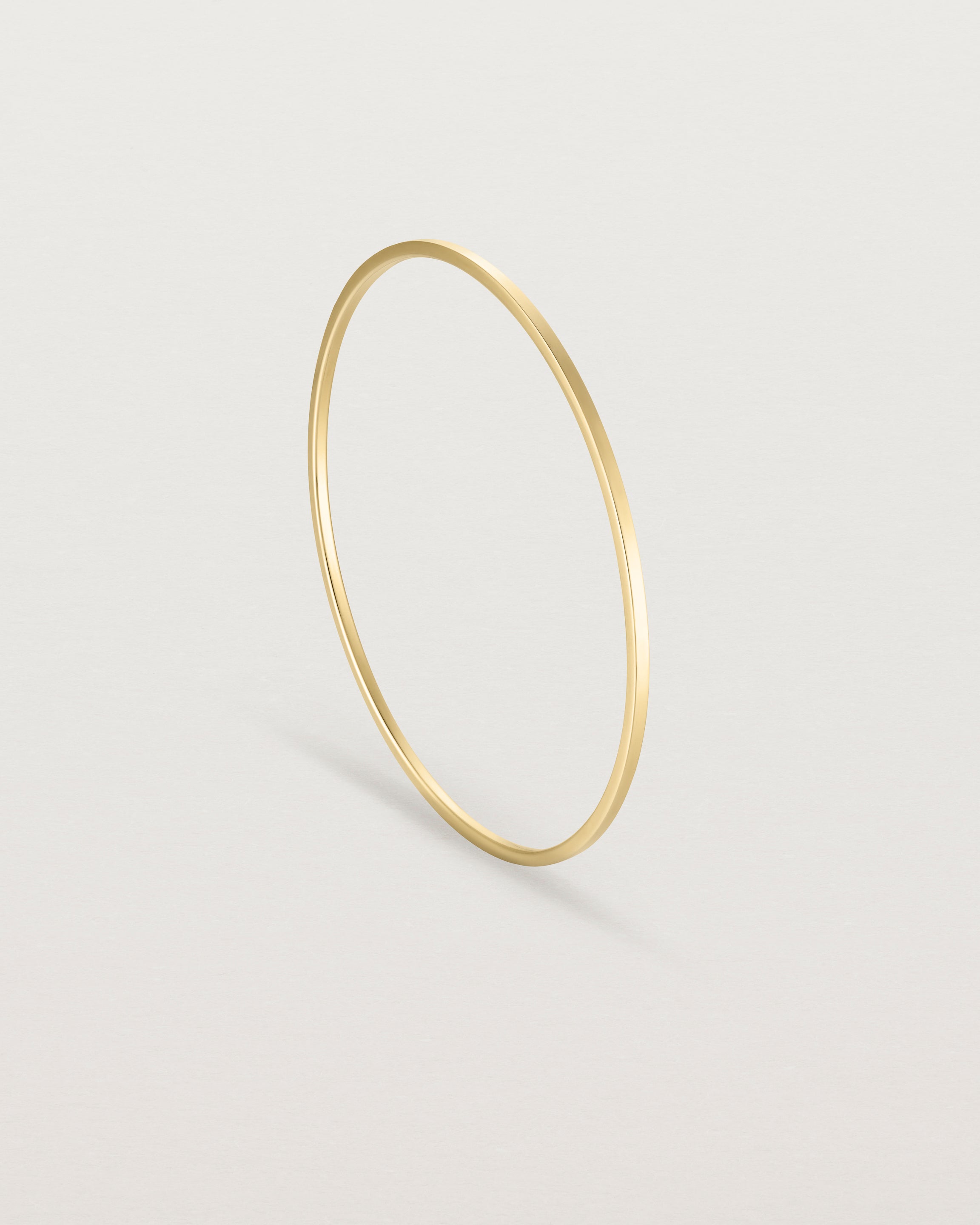 Standing view of the Antares Bangle in Yellow Gold.