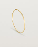 Standing view of the Antares Bangle in Yellow Gold.