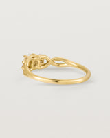 A vintage inspired yellow gold ring featuring white diamonds