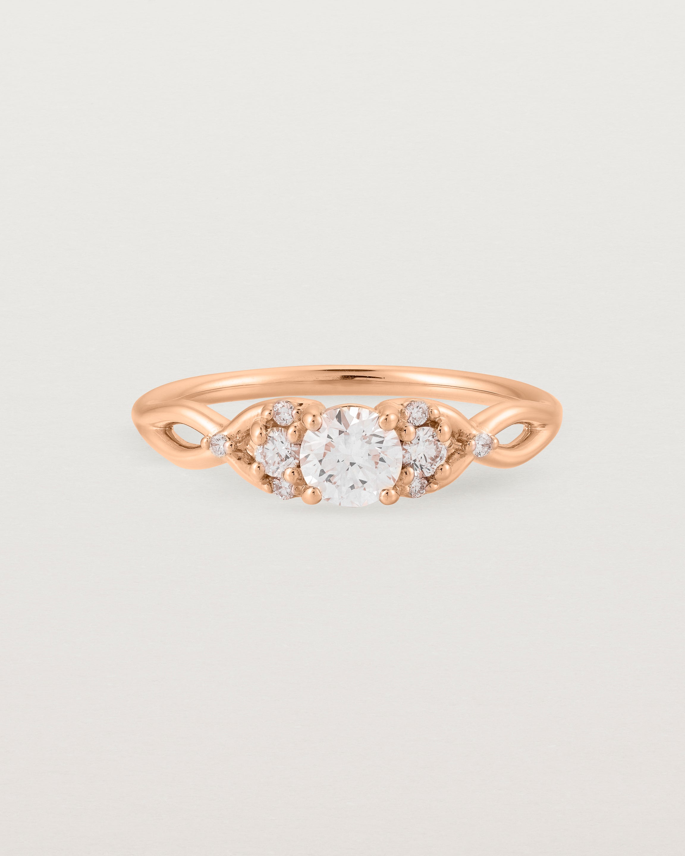 A vintage inspired rose gold ring featuring white diamonds