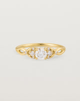 A vintage inspired yellow gold ring featuring white diamonds