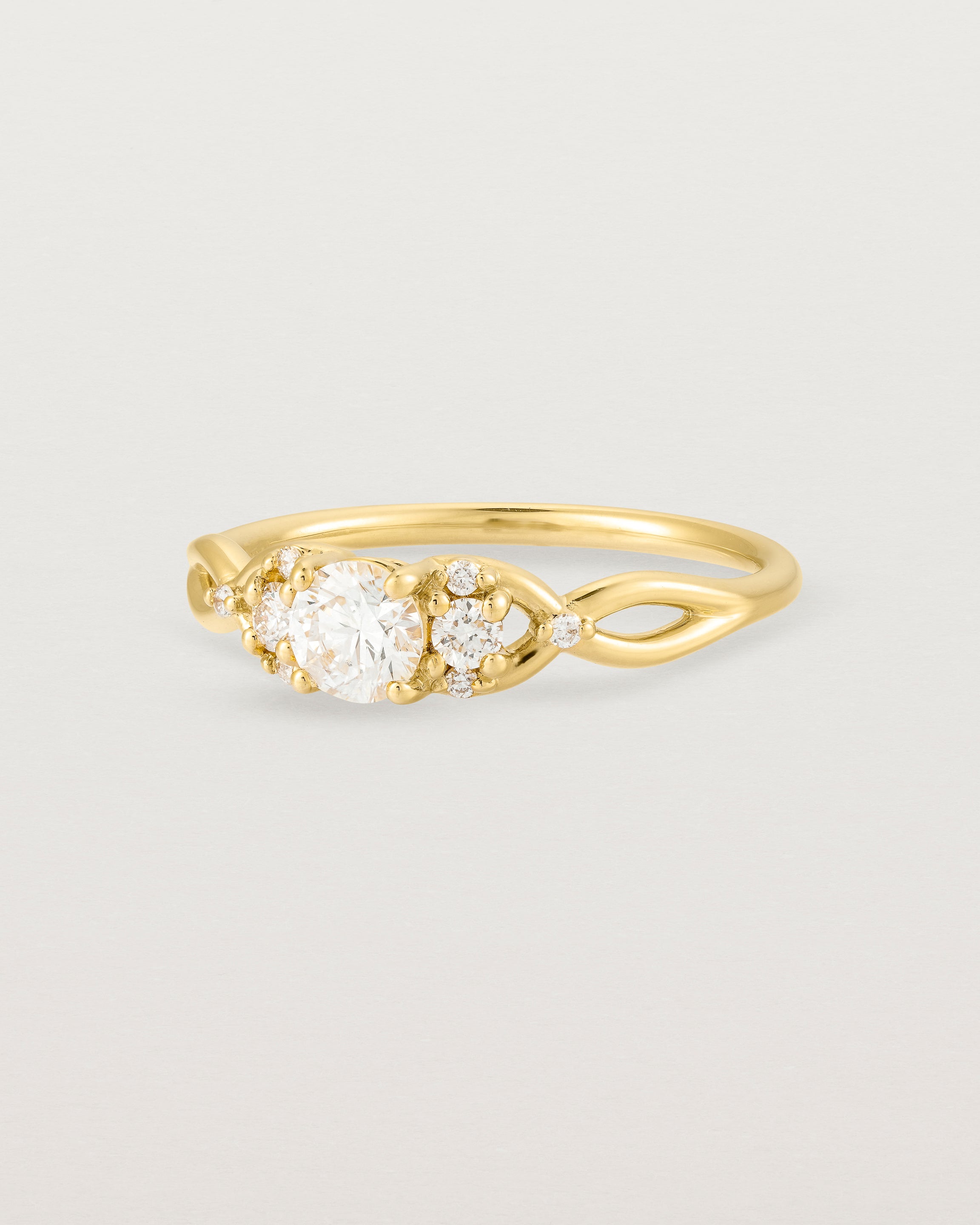 A vintage inspired yellow gold ring featuring white diamonds
