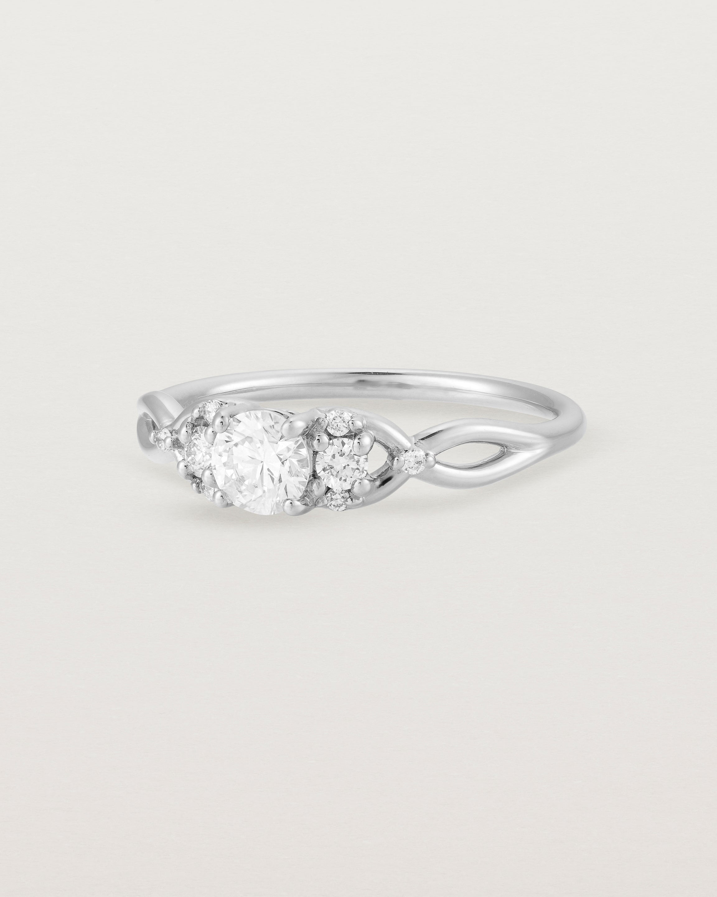 A vintage inspired white gold ring featuring white diamonds
