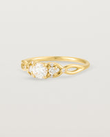 A vintage inspired yellow gold ring featuring white diamonds