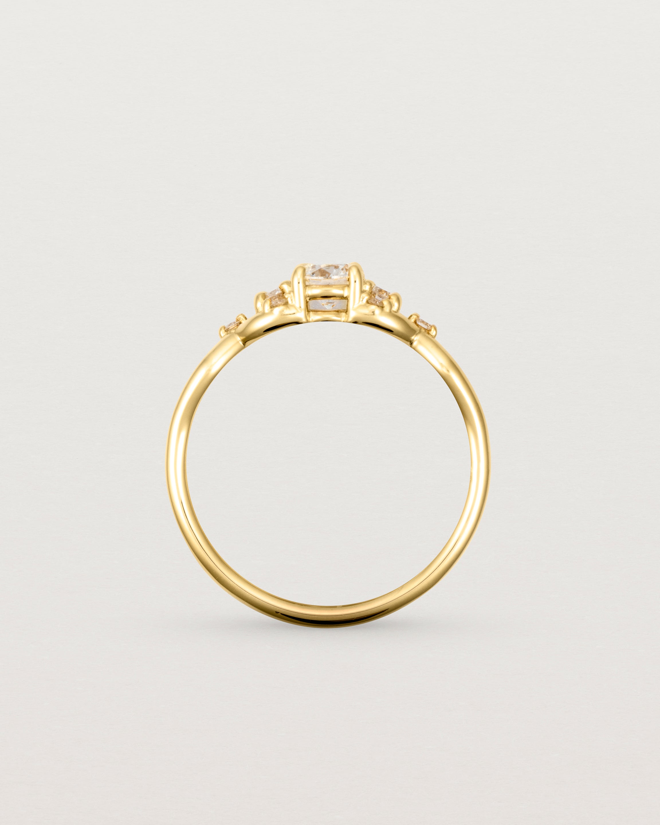 A vintage inspired yellow gold ring featuring white diamonds