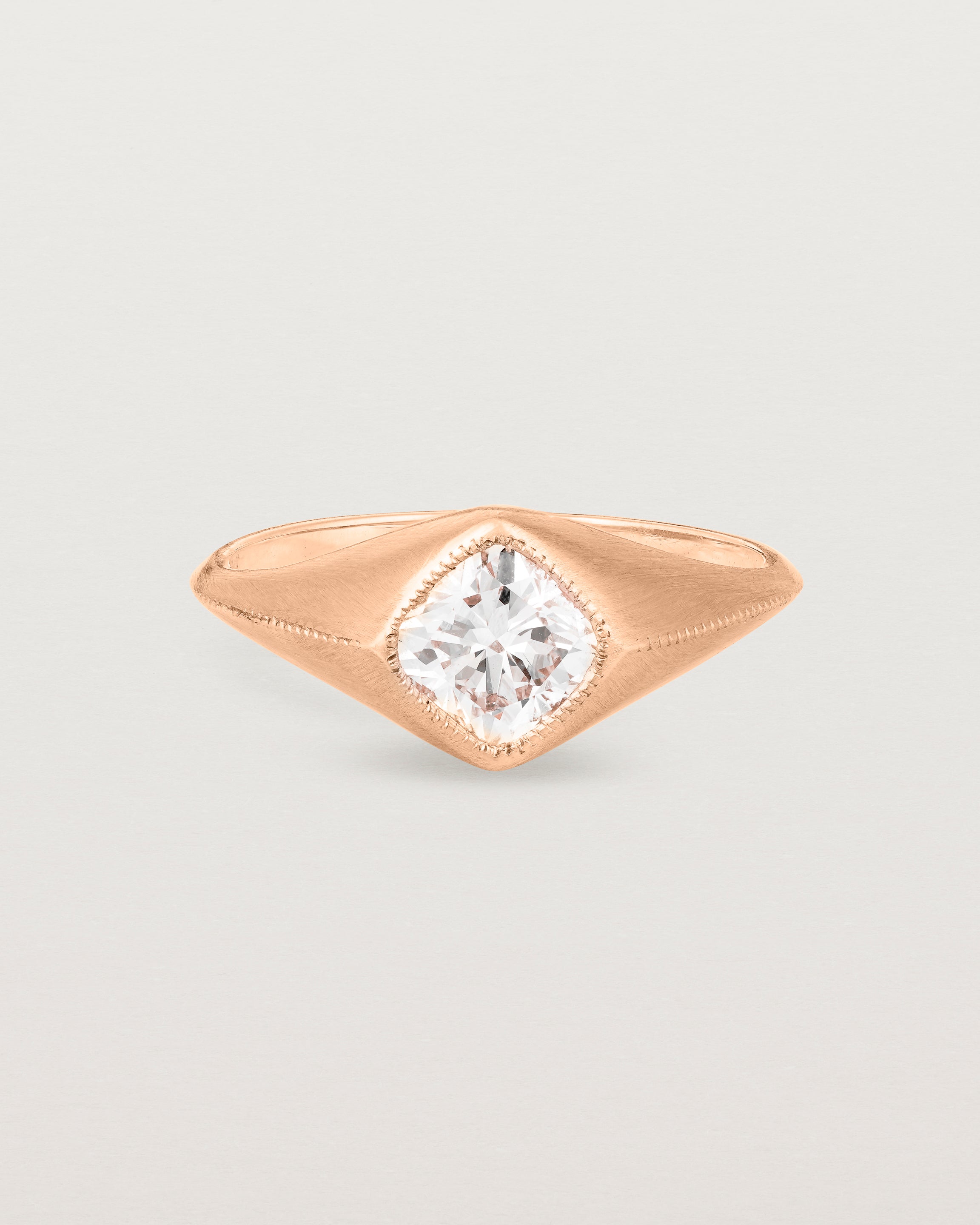 A rose gold Signet Ring featuring a cushion cut white diamond