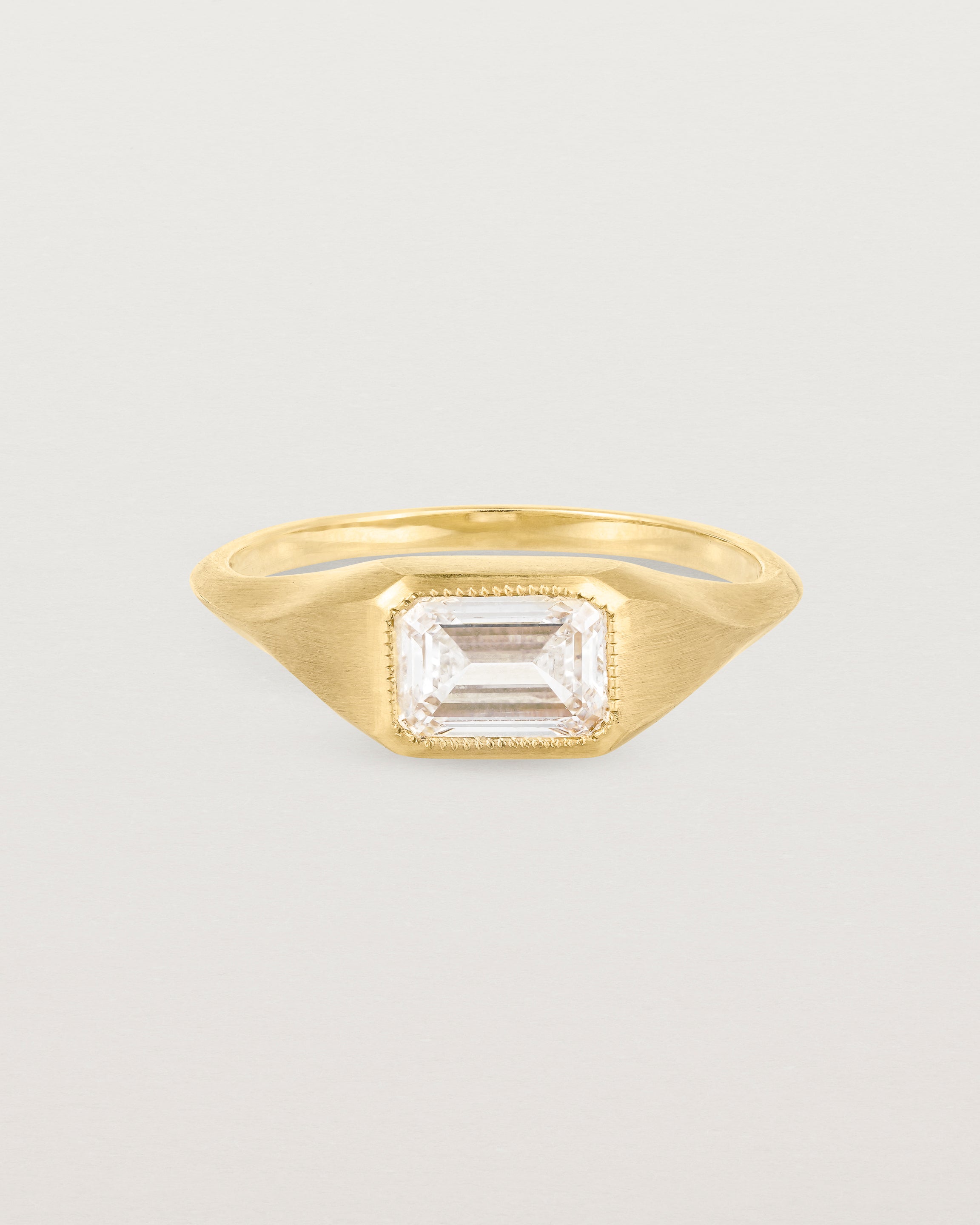 A yellow gold Signet Ring featuring a emerald cut white diamond. _label: Matte Finished Example