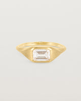 A yellow gold Signet Ring featuring a emerald cut white diamond