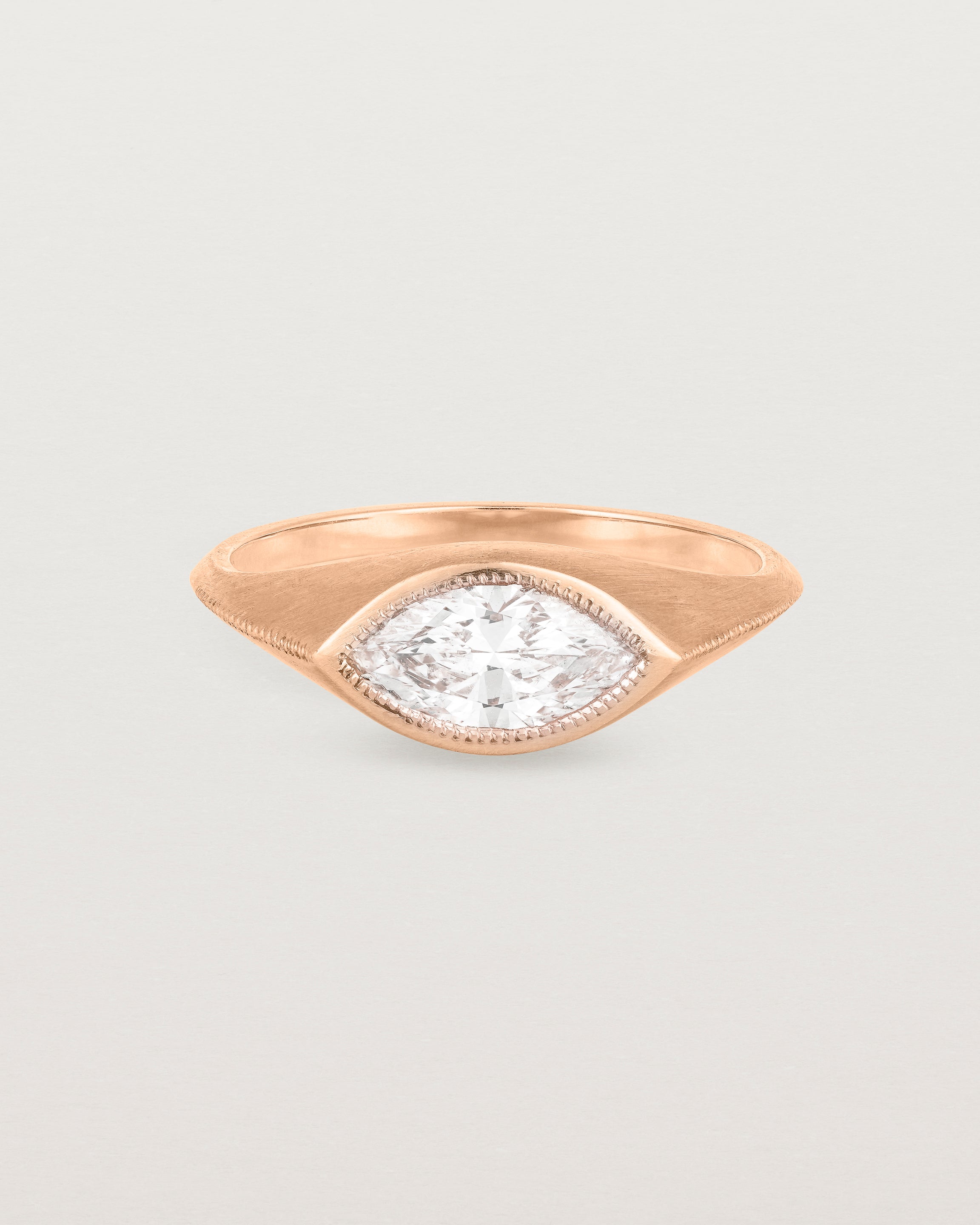A rose gold Signet Ring featuring a marquise cut white diamond