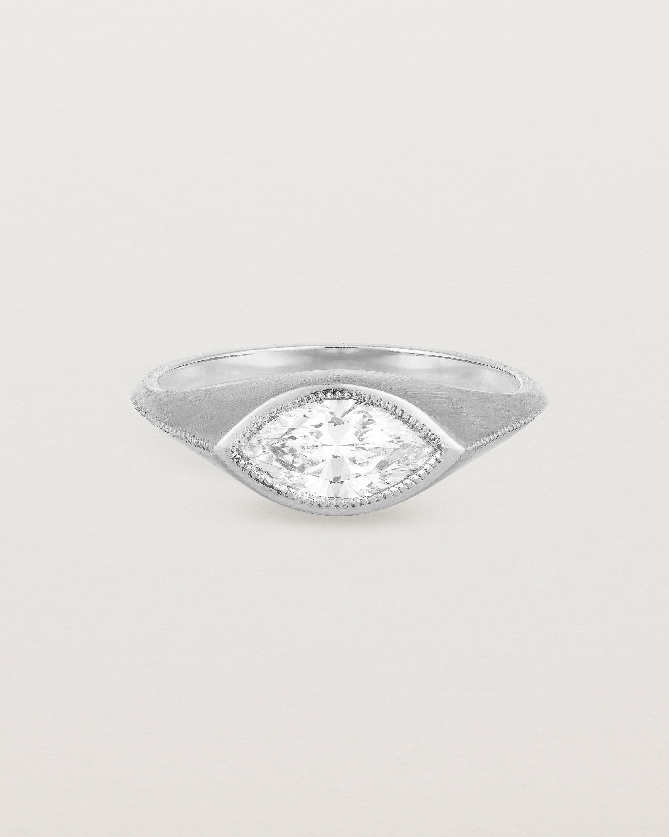 A white gold Signet Ring featuring a marquise cut white diamond