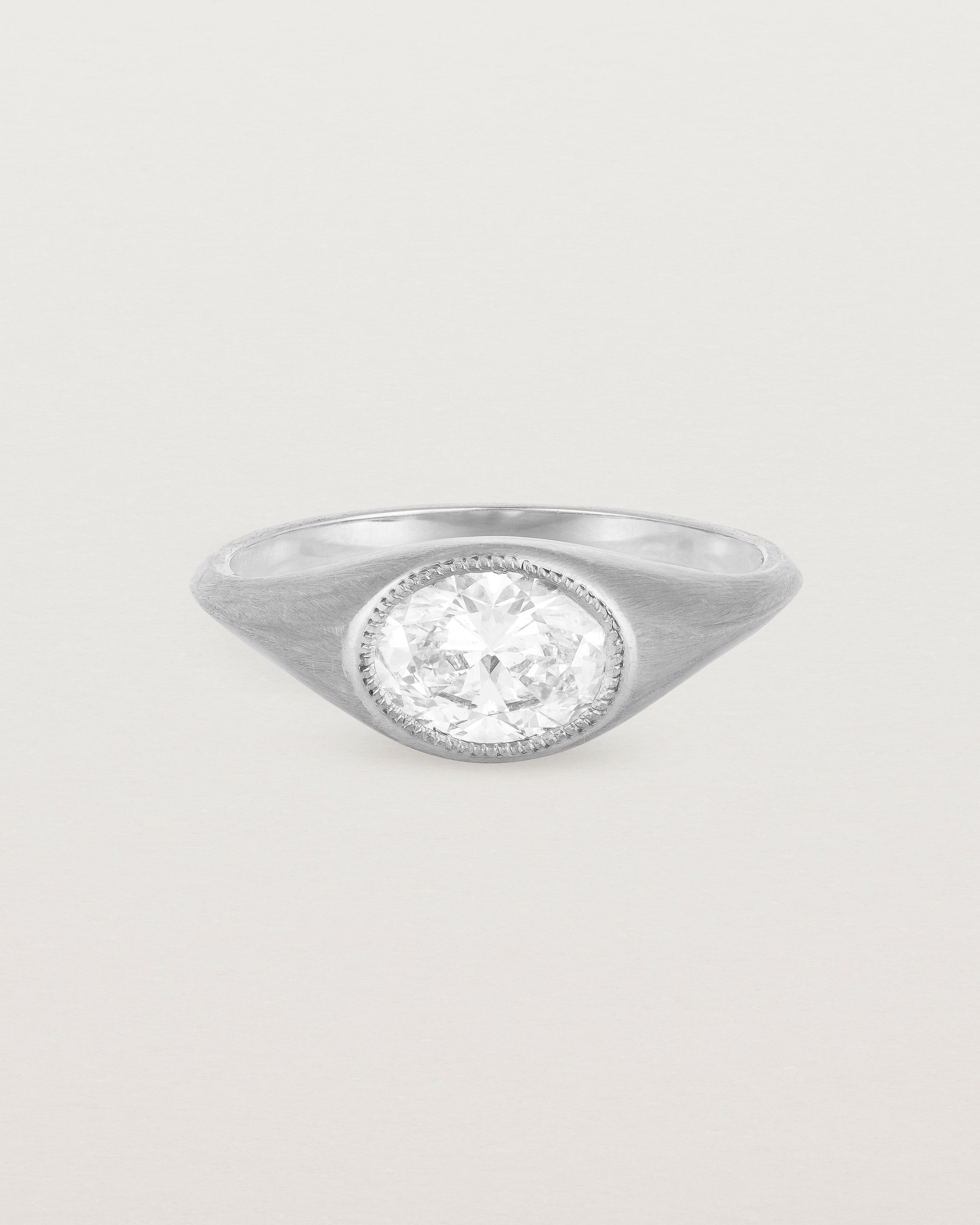 A white gold Signet Ring featuring a oval cut white diamond