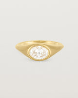 A yellow gold Signet Ring featuring a oval cut white diamond