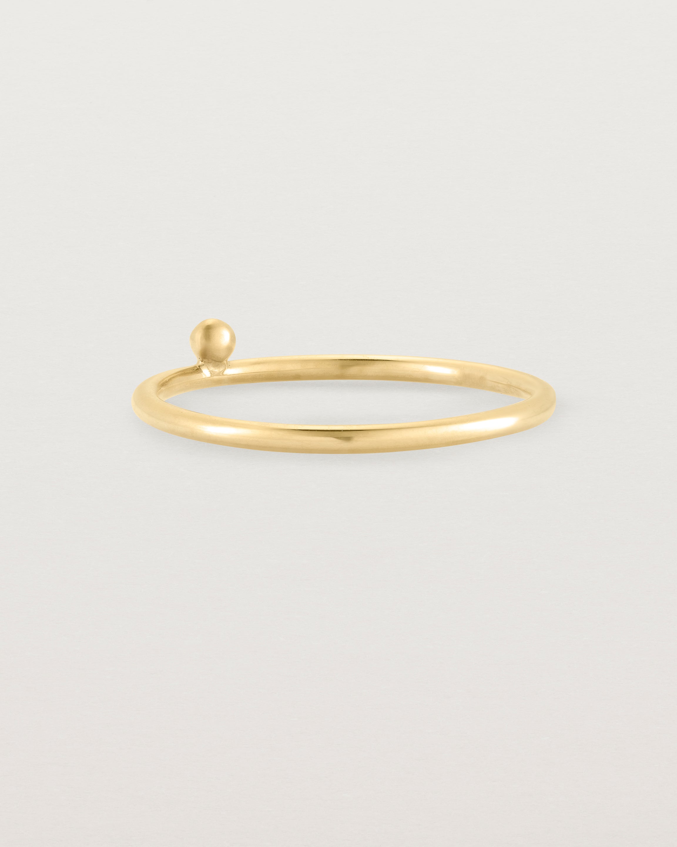 yellow gold fine ring with a single dot detail