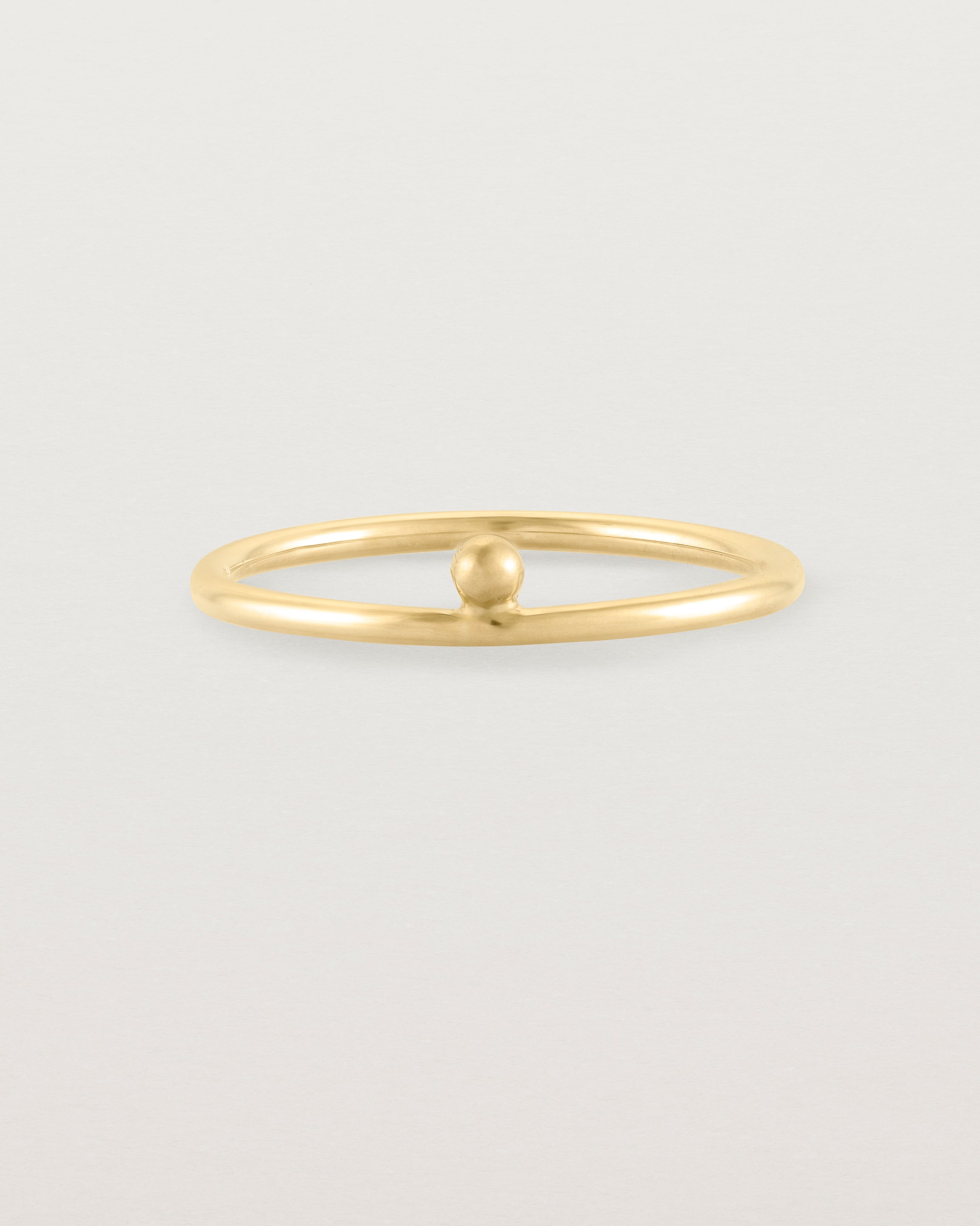 yellow gold fine ring with a single dot detail