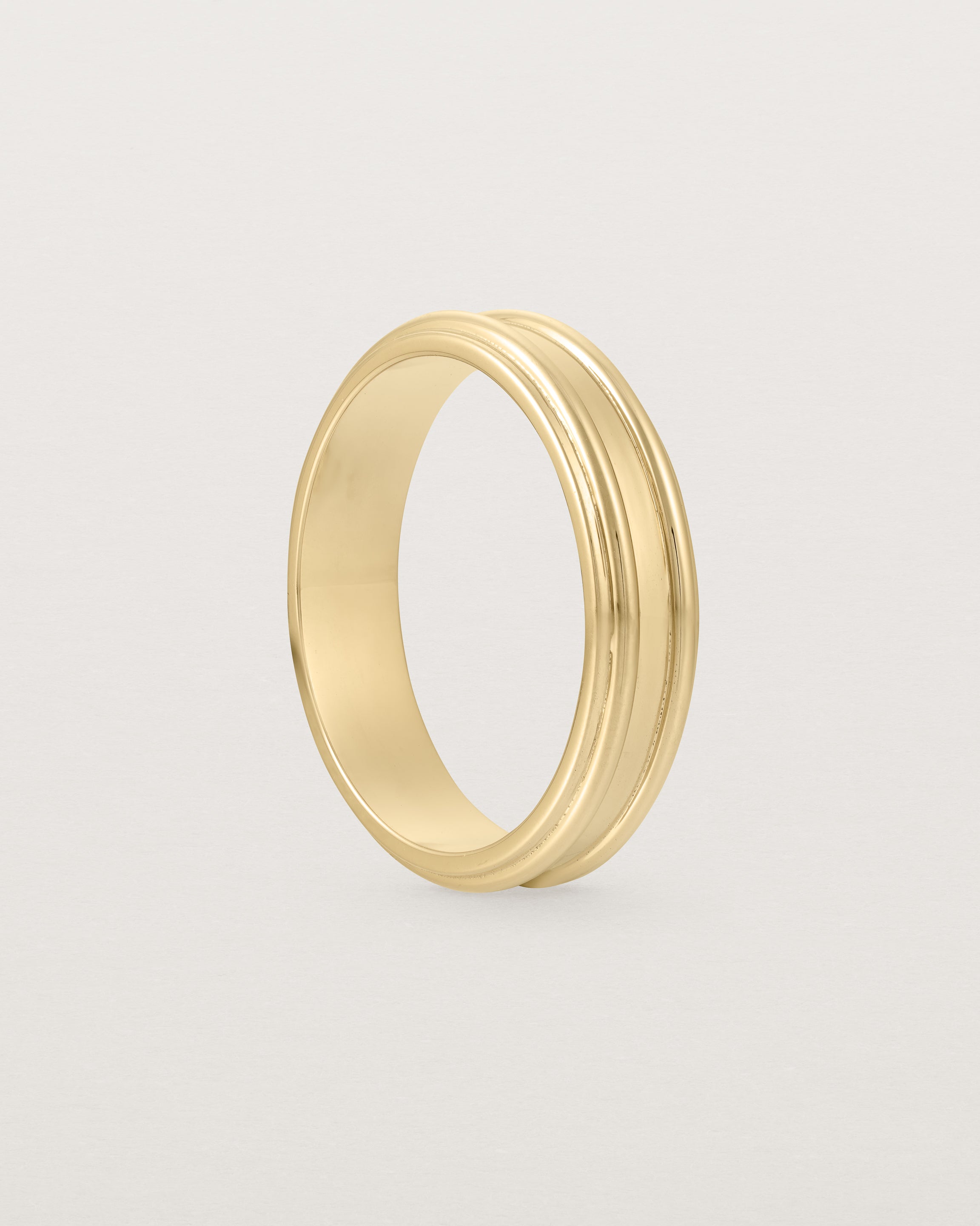 Standing view of the Border Wedding Ring | 5mm | Yellow Gold.