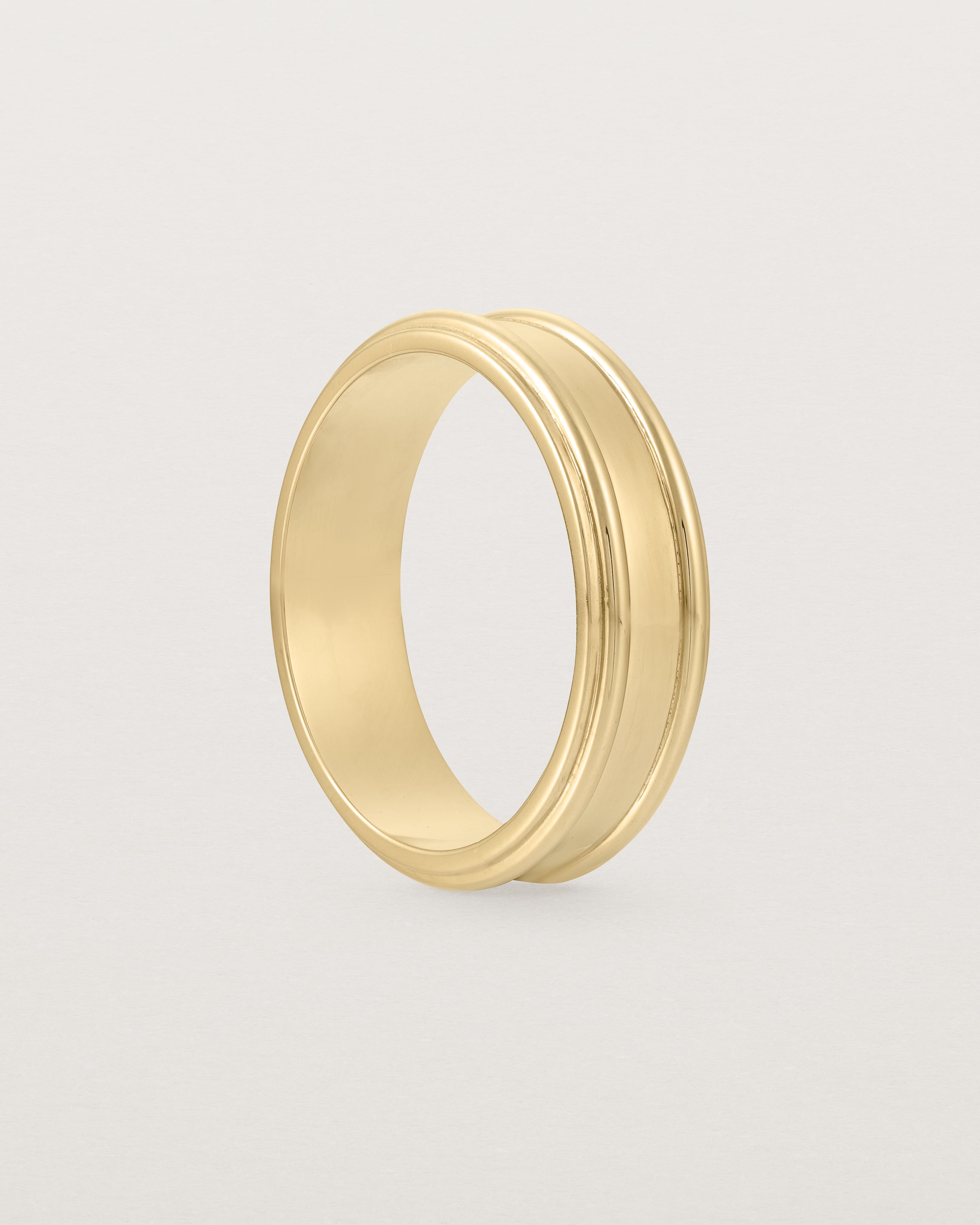 Standing view of the Border Wedding Ring | 6mm | Yellow Gold.