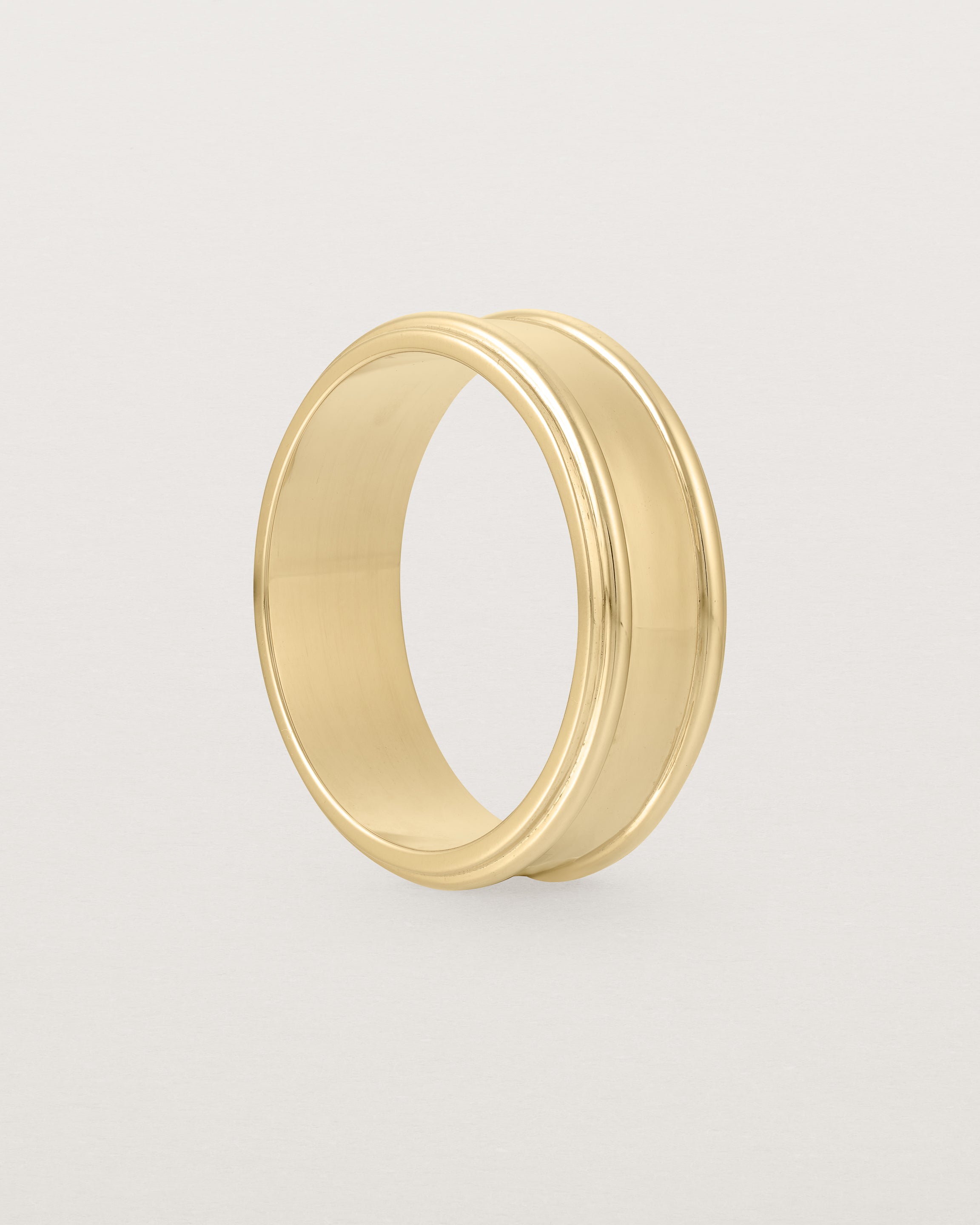 Standing view of the Border Wedding Ring | 7mm | Yellow Gold.