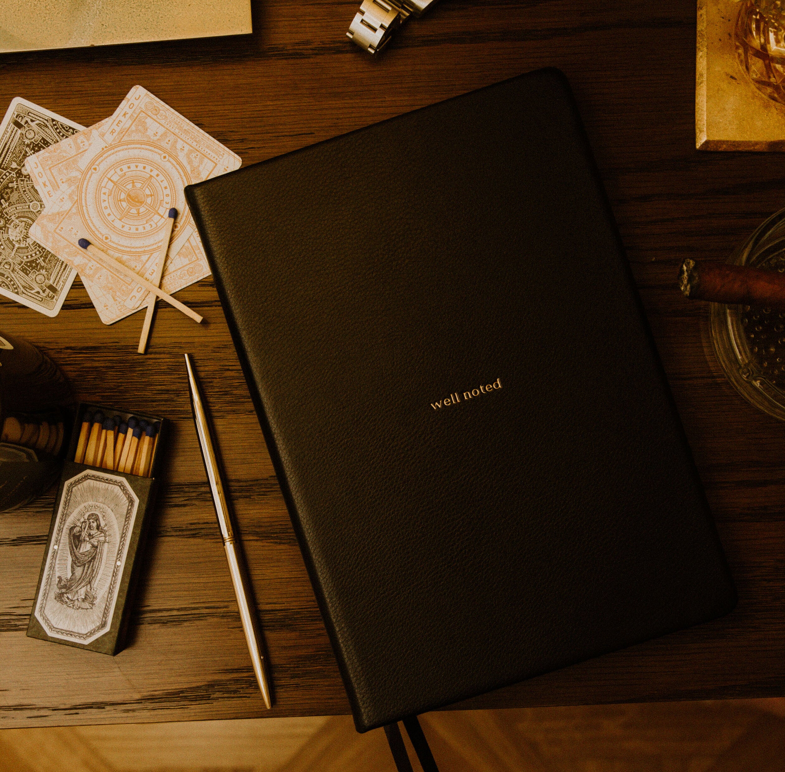 High quality black leather Notebook by Wellnoted on a desk