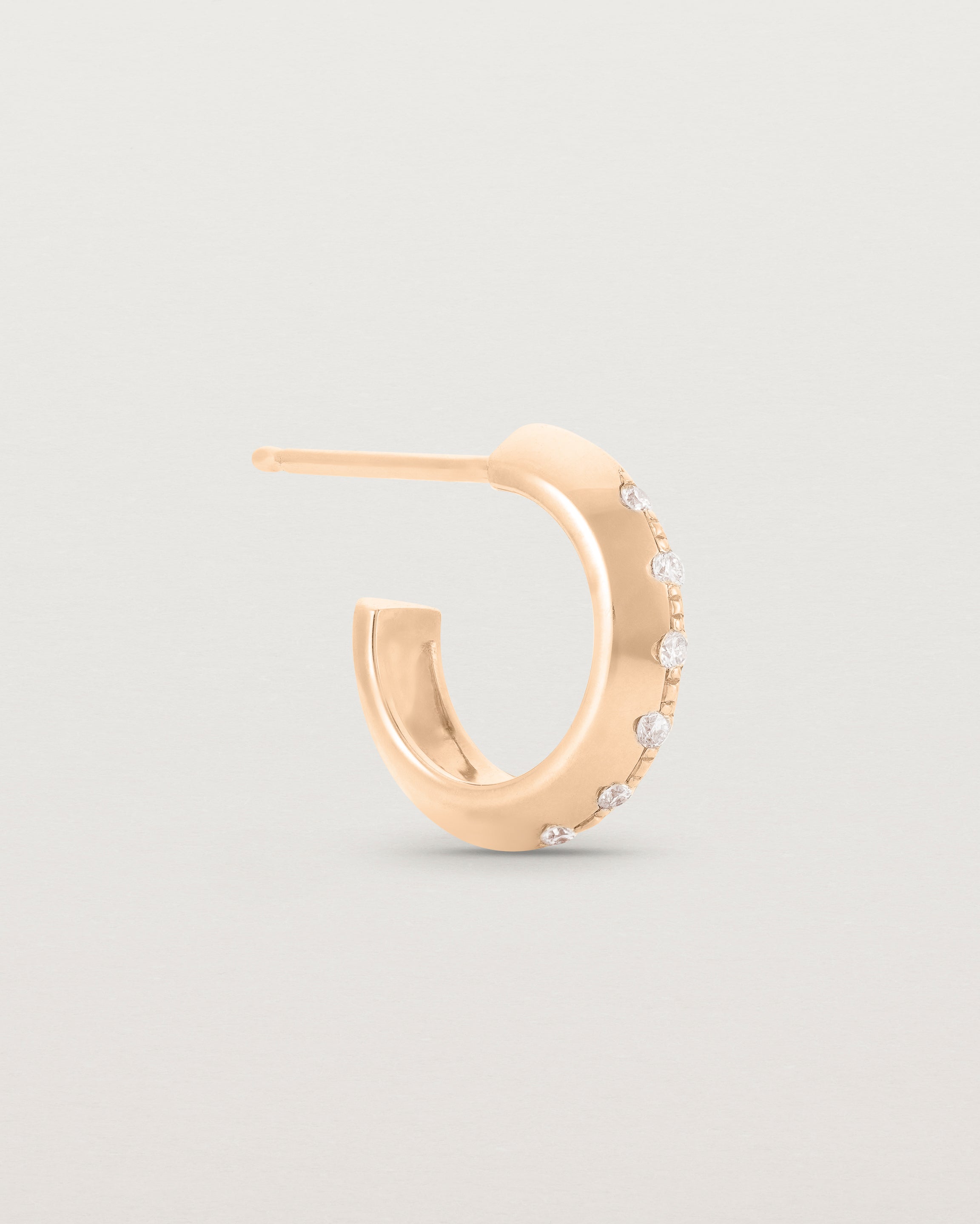 A side view of the Cascade Knife Edge Hoops | Diamonds | Rose Gold.