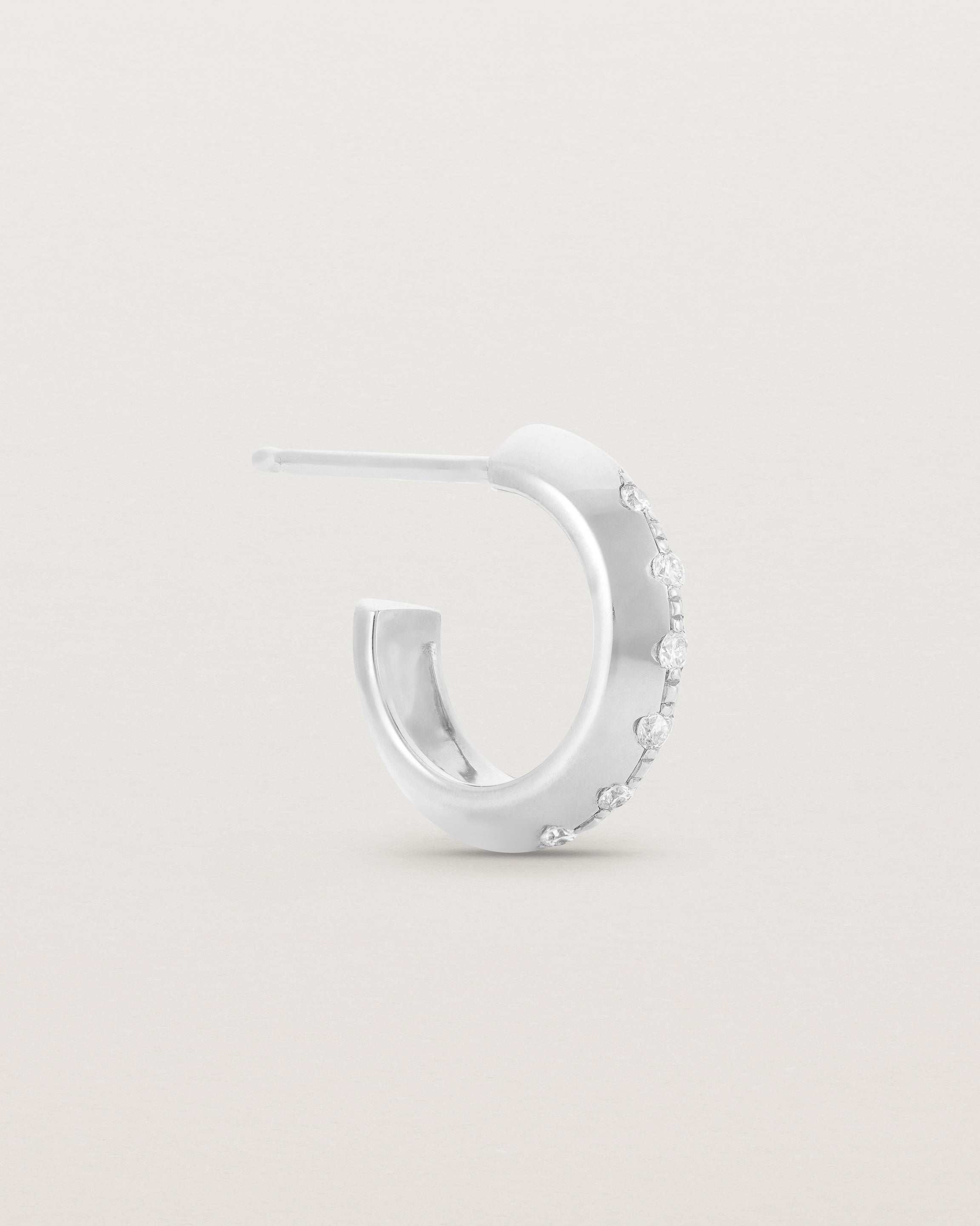 A side view of the Cascade Knife Edge Hoops | Diamonds | White Gold.