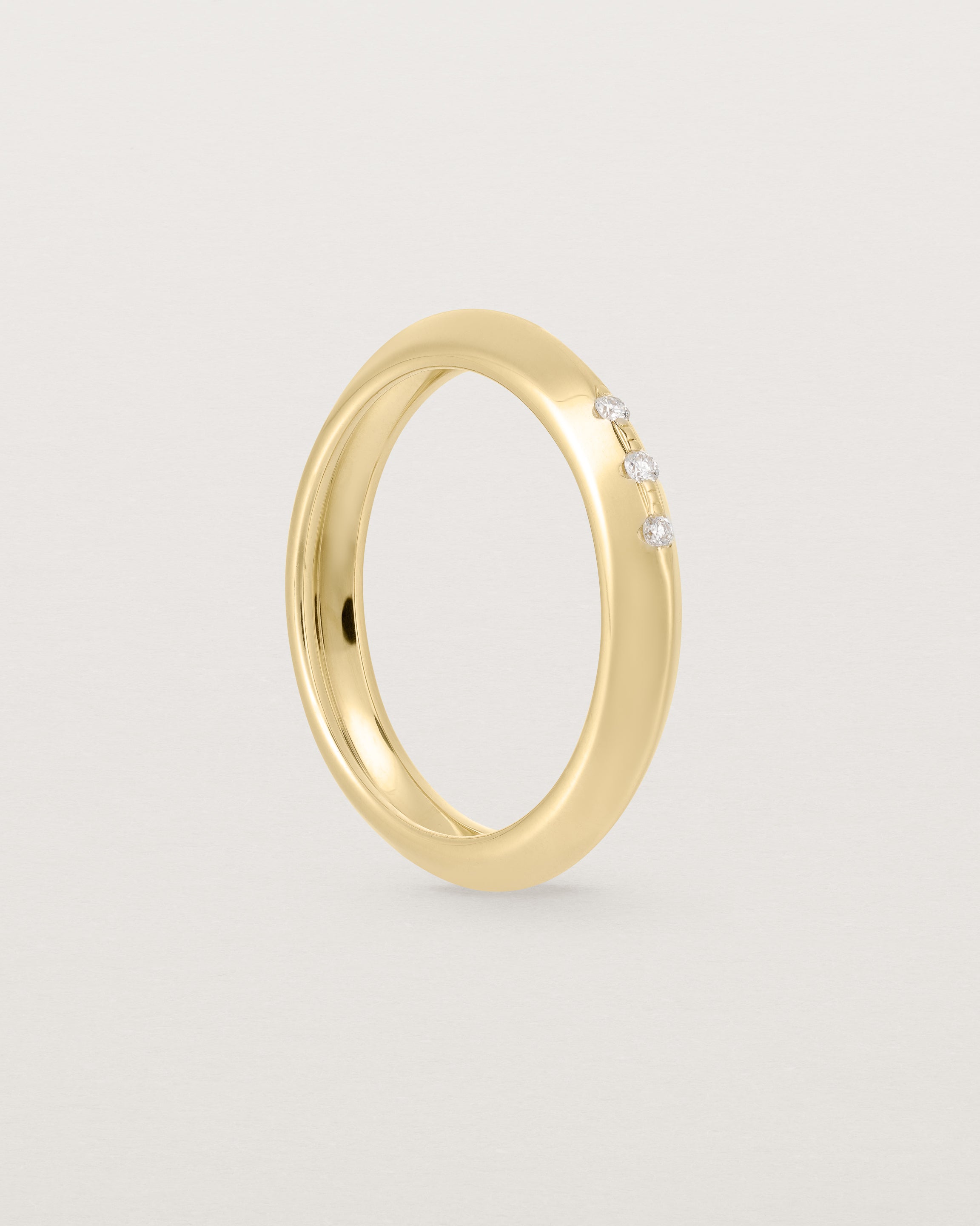 yellow gold band with three white diamonds