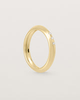 yellow gold band with three white diamonds