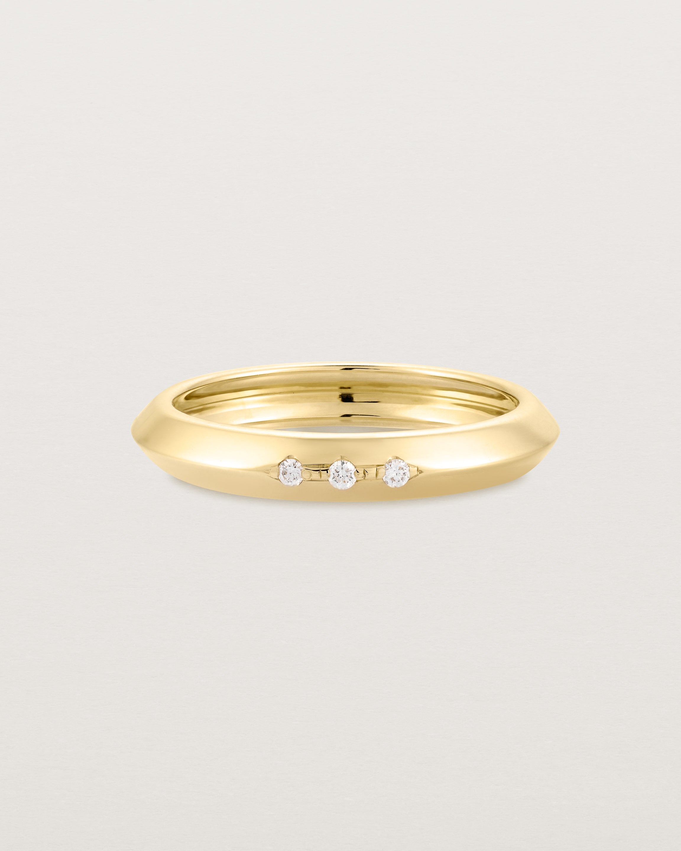 yellow gold band with three white diamonds