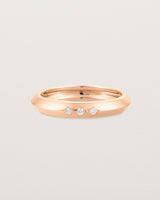 A rose gold ring with white diamonds