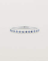 A fine white  gold wedding ring with thirteen blue sapphires