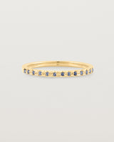 A fine yellow gold wedding ring with thirteen blue sapphires