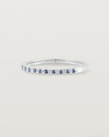 A fine white  gold wedding ring with thirteen blue sapphires