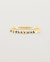 A fine yellow gold wedding ring with thirteen blue sapphires