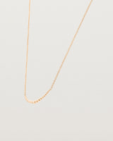 Angled view of the Crescent Necklace in Rose Gold.