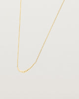 Angled view of the Crescent Necklace in yellow gold.