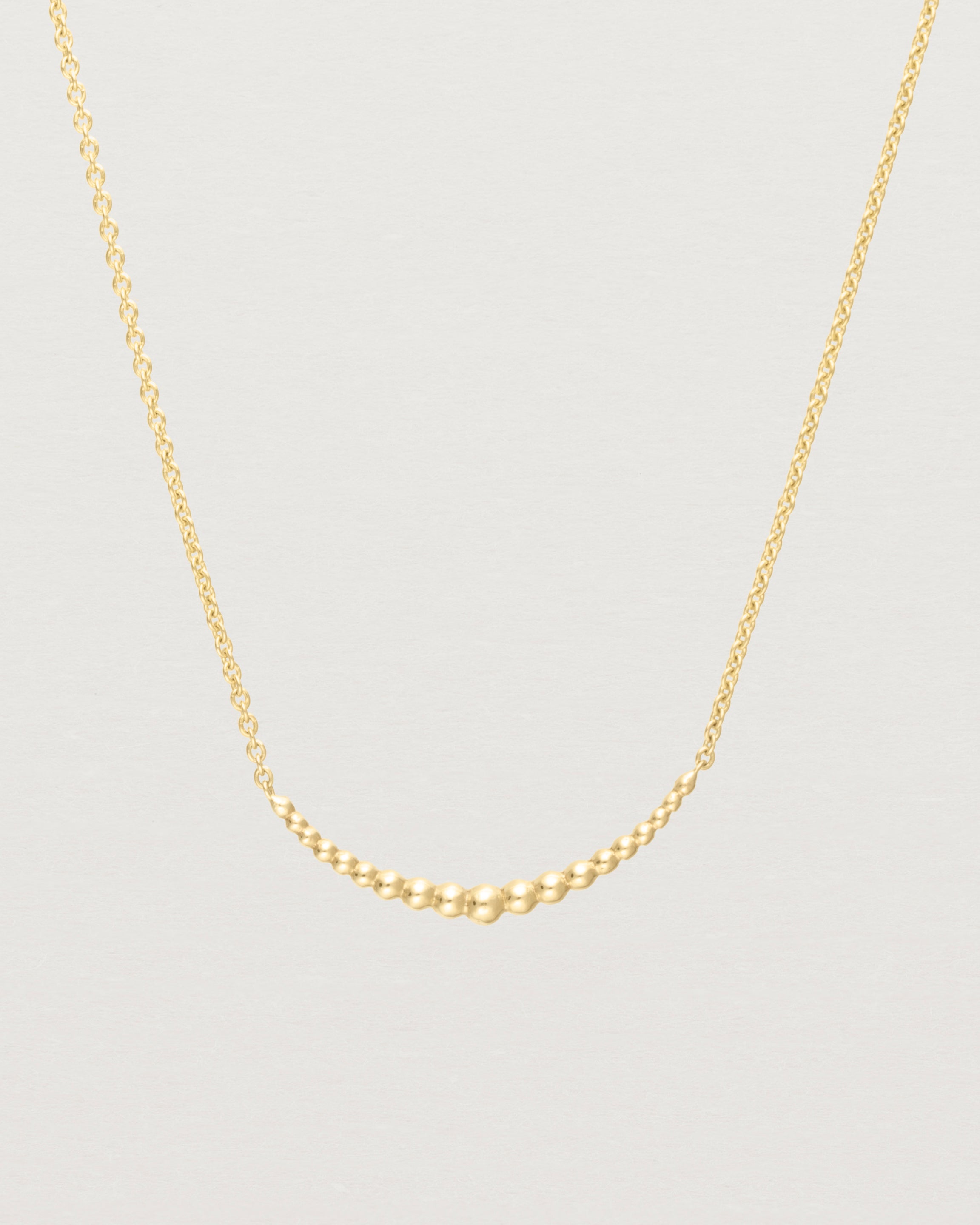 Close up of the Crescent Necklace in yellow gold.