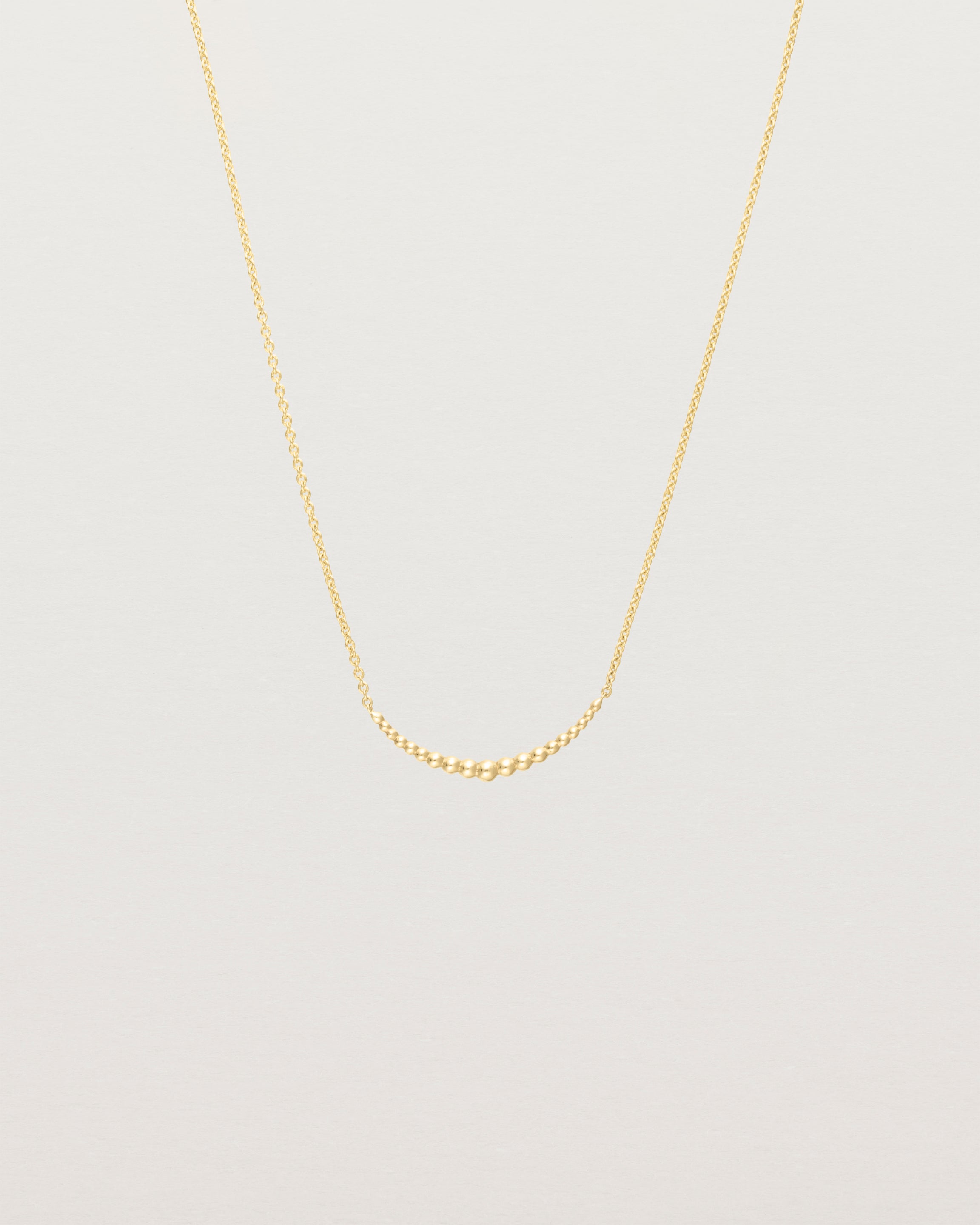 Front view of the Crescent Necklace in yellow gold.