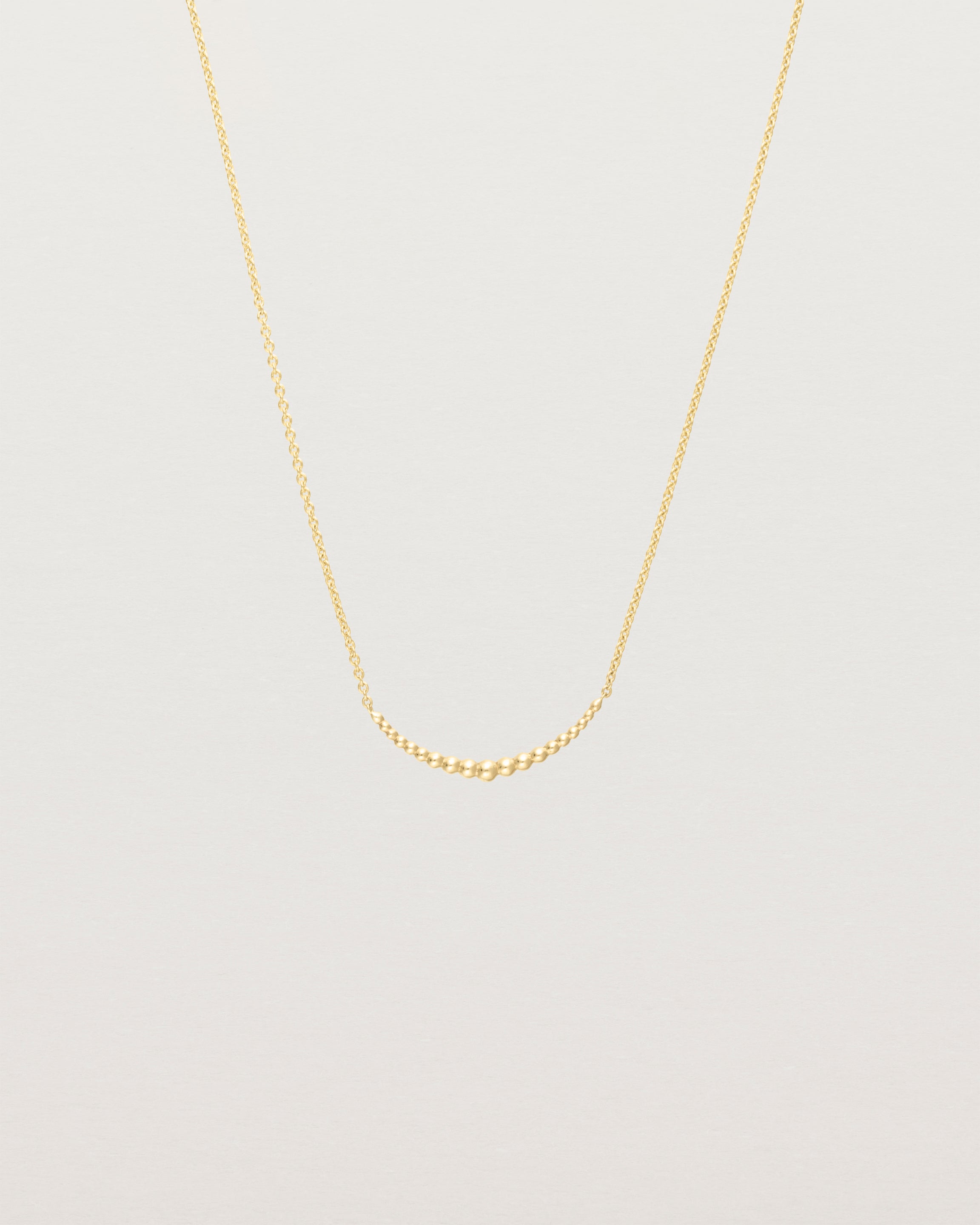 Front view of the Crescent Necklace in yellow gold.