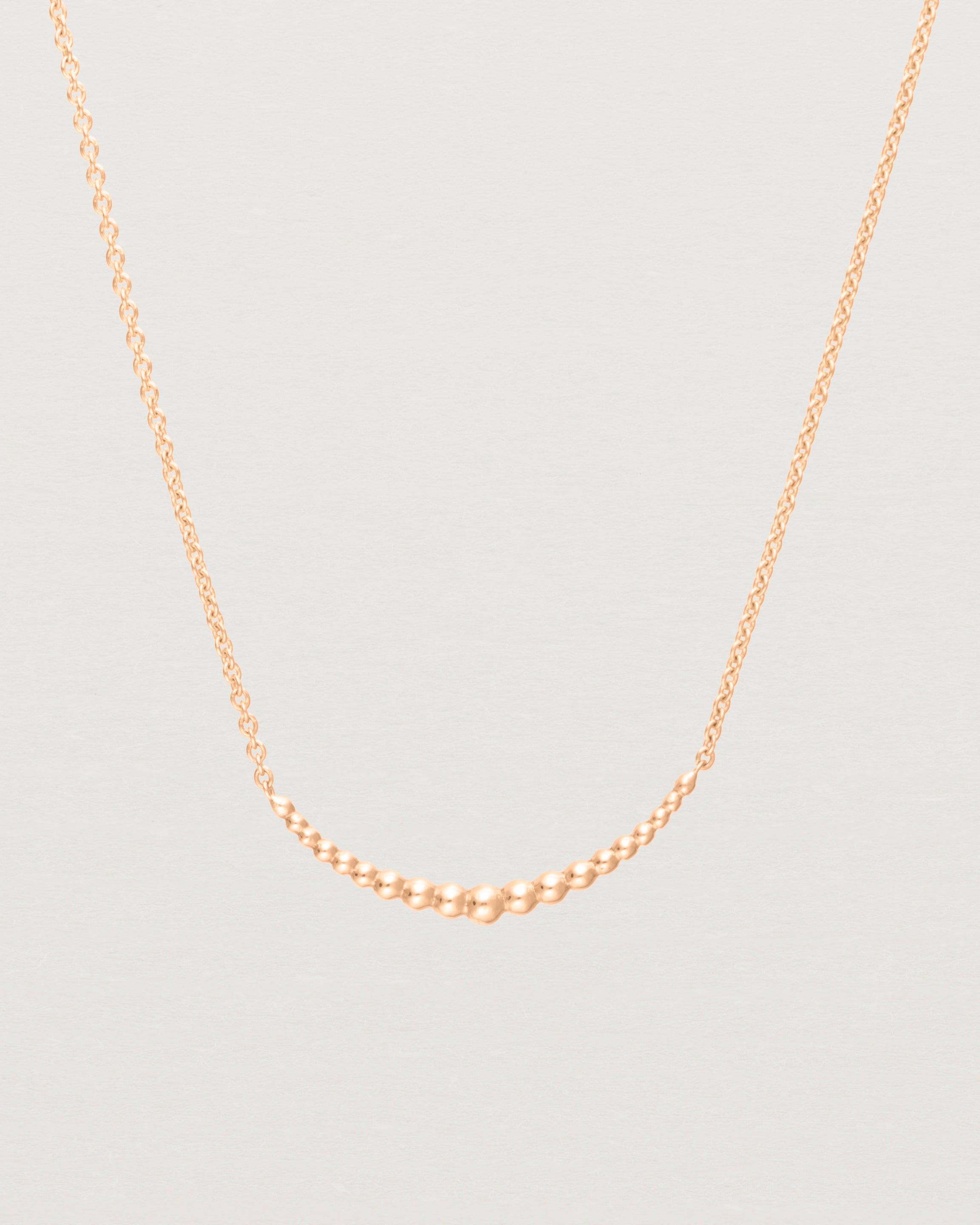 Close up view of the Crescent Necklace in Rose Gold. 
