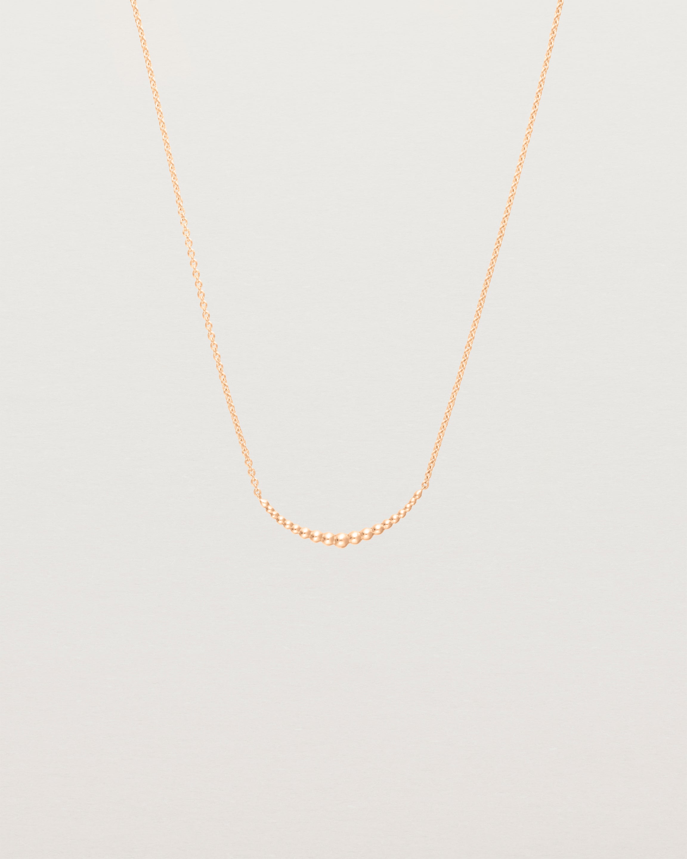 Front view of the Crescent Necklace in Rose Gold.