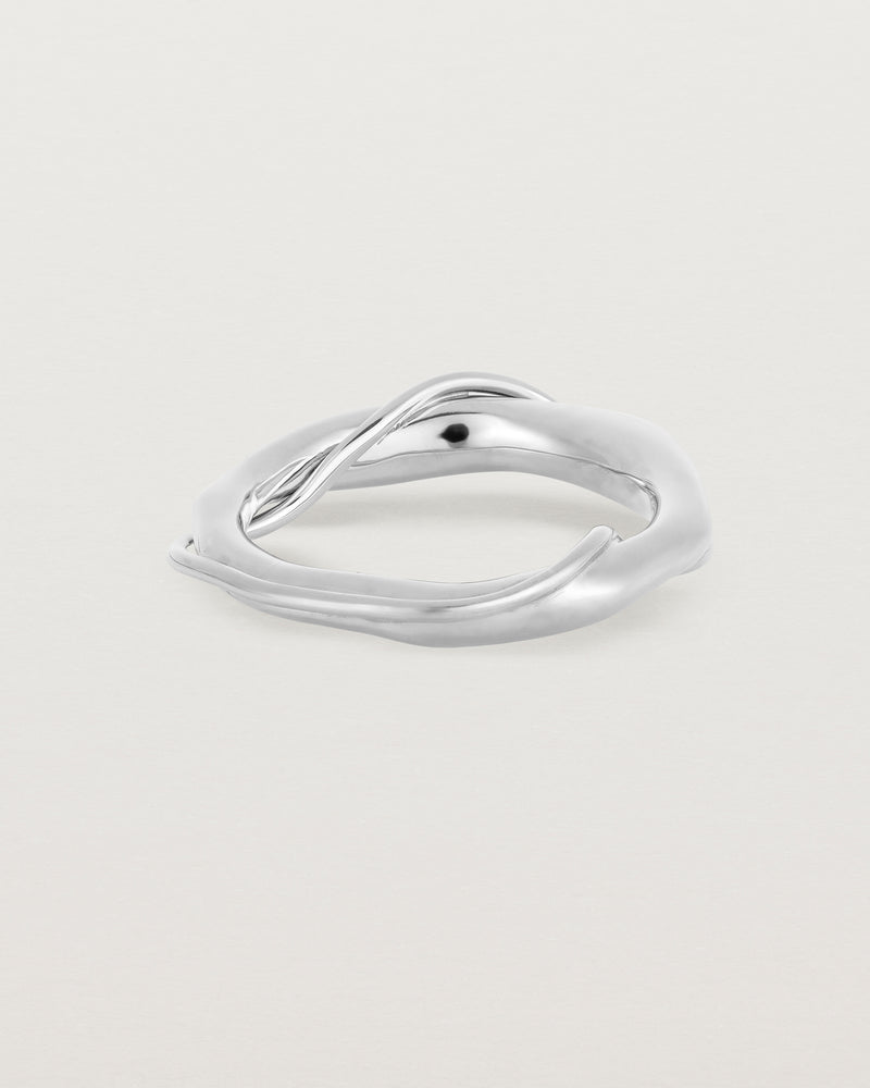 A silver ring featuring two entwined metal bands