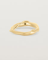 A yellow gold ring featuring two entwined metal bands