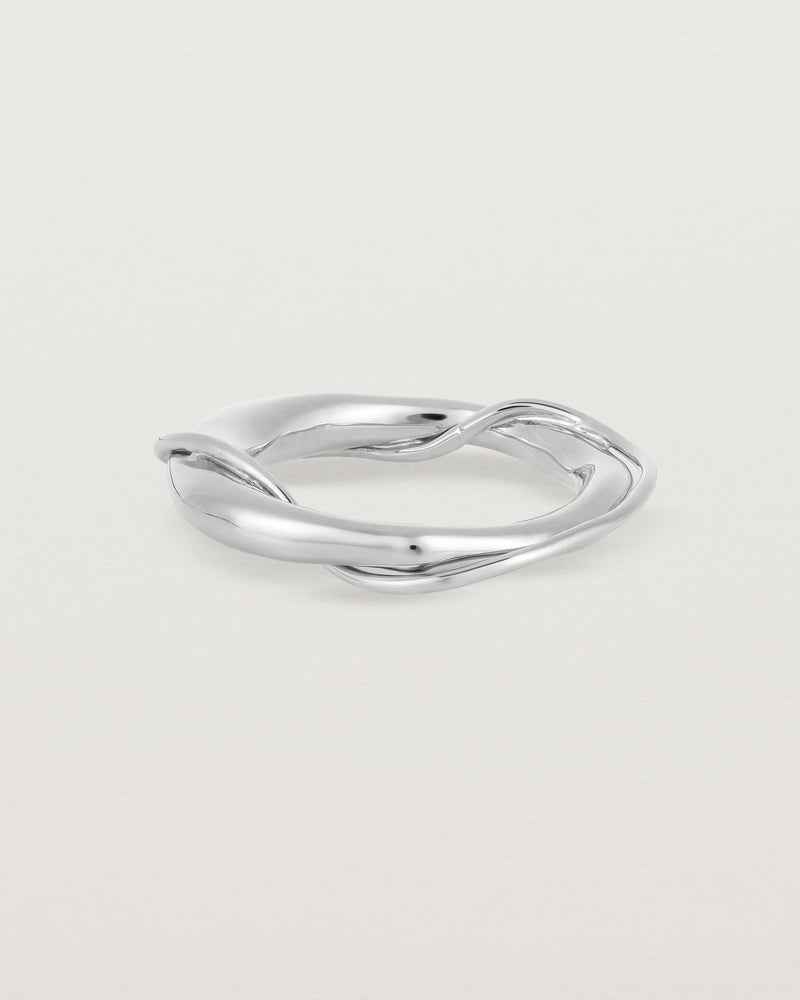A silver ring featuring two entwined metal bands