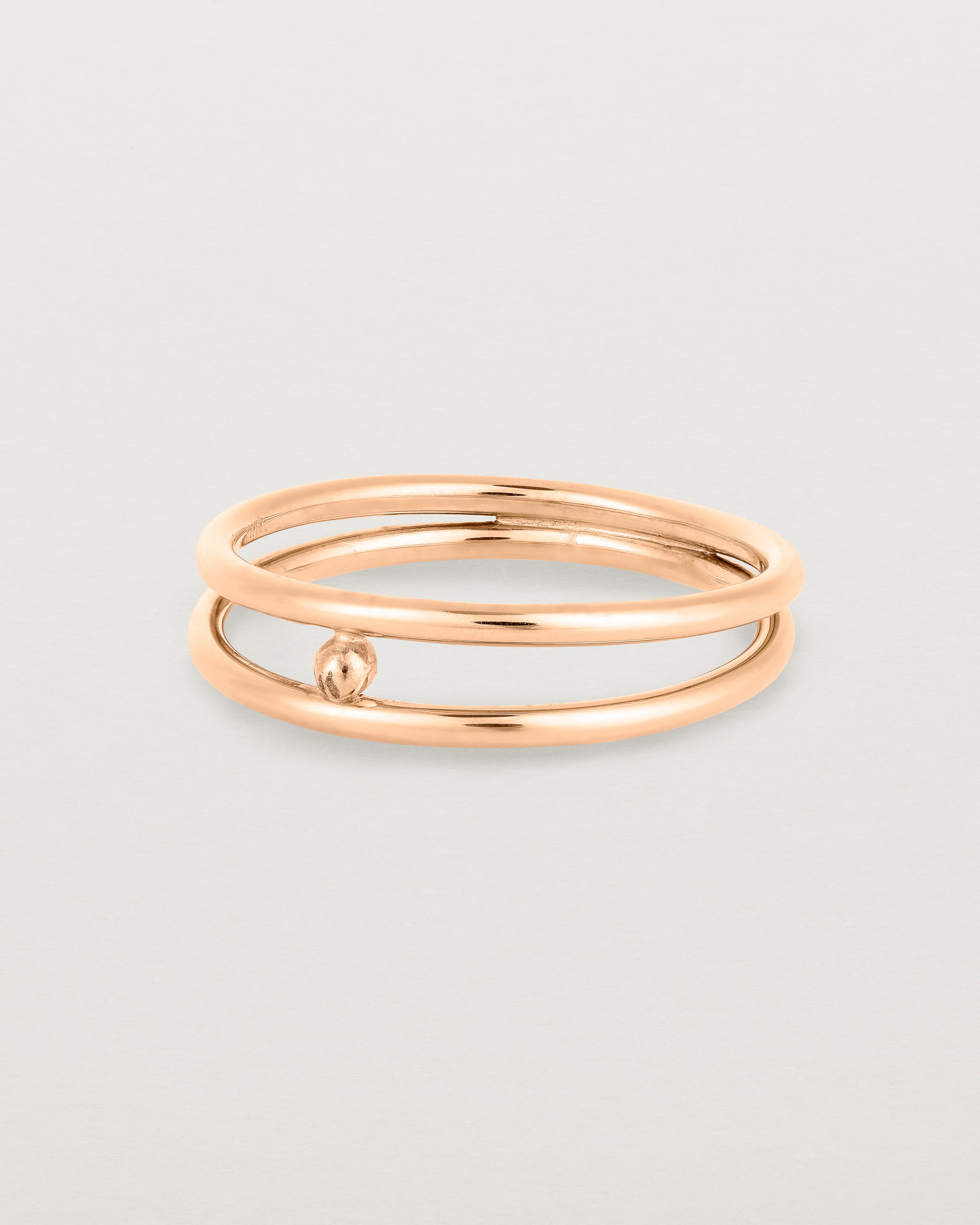 Angled view of the Double Reliquum Ring in Rose Gold.